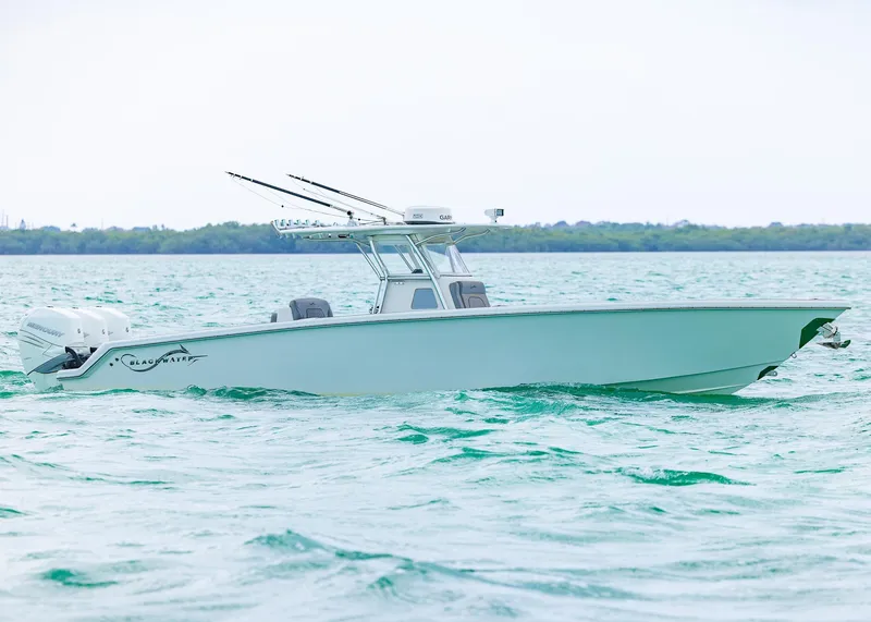 Slide: The Image of 2021 Blackwater 36 Sport boat cruising on turquoise water. - 1