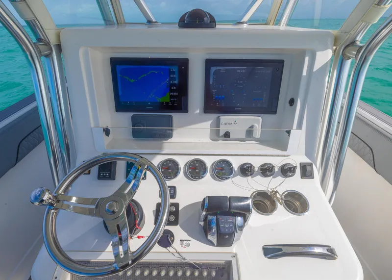 Slide: The Image of Control panel of 2021 Blackwater 36 Sport boat with navigation screens and steering wheel. - 10