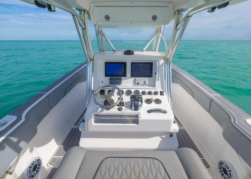 Slide: The Image of Cockpit of 2021 Blackwater 36 Sport boat with modern controls on turquoise water. - 11