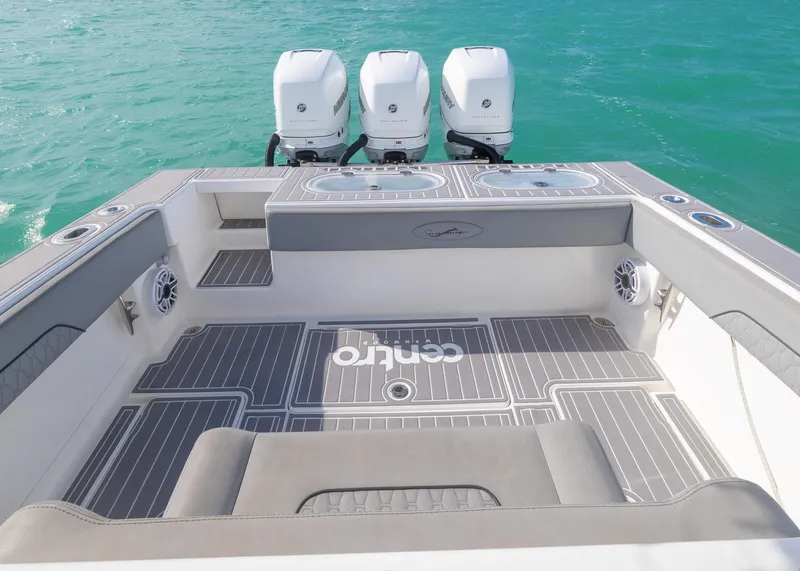 Slide: The Image of 2021 Blackwater 36 Sport boat with triple engines on turquoise water. - 14