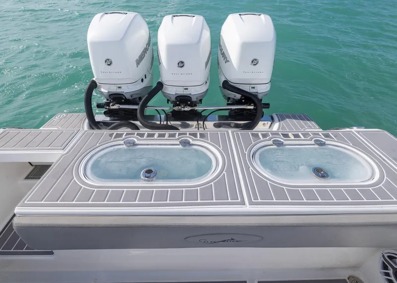 Slide: The Image of Triple outboard motors on a 2021 Blackwater 36 Sport boat, with dual livewells. - 15
