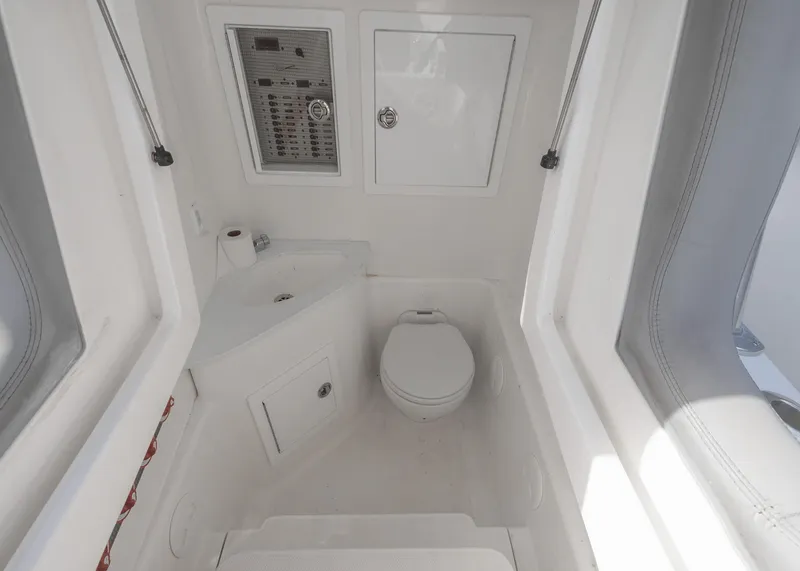 Slide: The Image of 2021 Blackwater 36 Sport boat interior with toilet and control panel. - 18