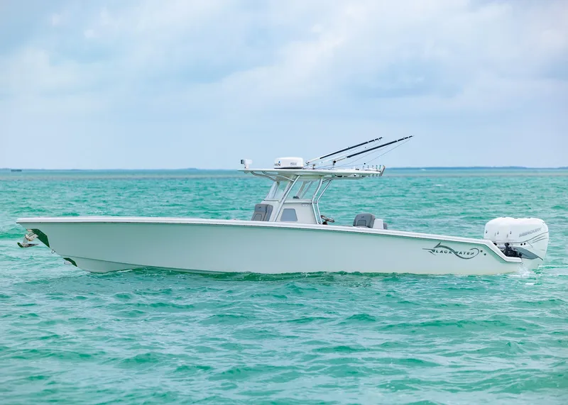 Slide: The Image of 2021 Blackwater 36 Sport boat on turquoise ocean water under cloudy sky. - 19