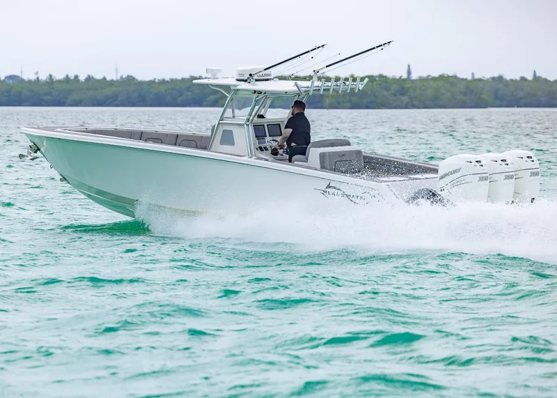 Slide: The Image of 2021 Blackwater 36 Sport boat cruising on turquoise water. - 21