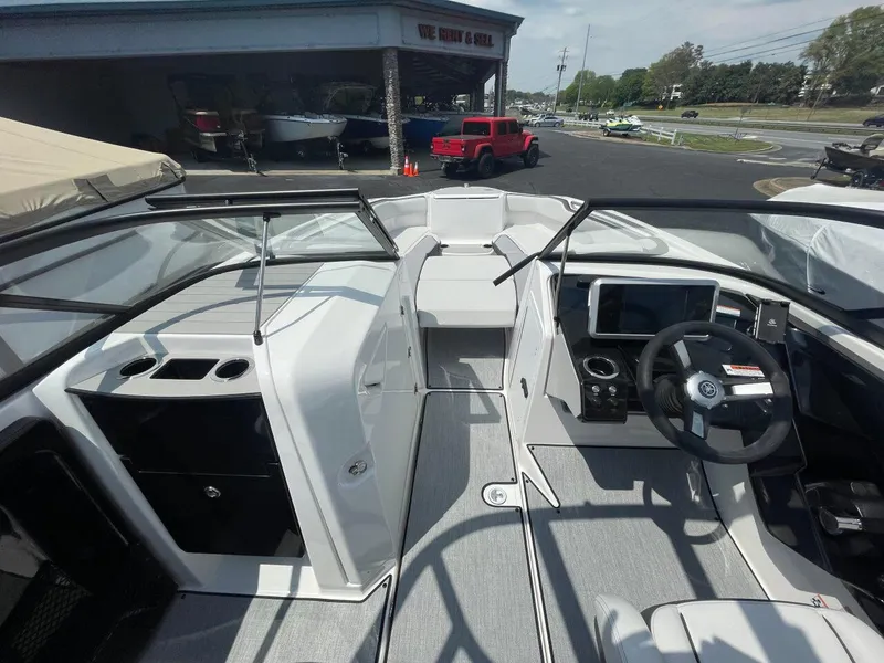 Slide: The Image of 2025 Yamaha Boats AR250 interior with steering wheel, dashboard, and seating area. - 14