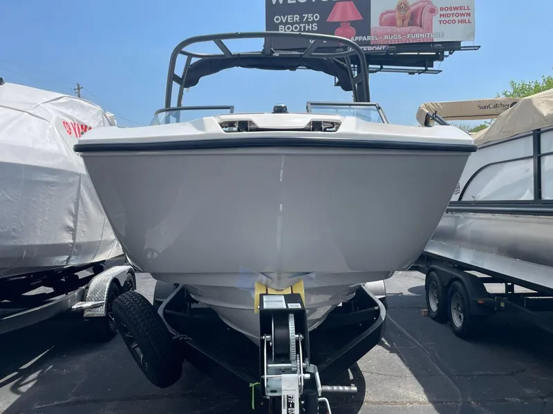 Slide: The Image of 2025 Yamaha Boats AR250 on trailer, front view, displayed outdoors. - 2