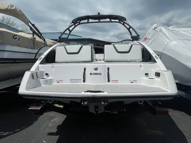 Slide: The Image of 2025 Yamaha Boats AR250, rear view, white exterior, parked outdoors. - 3