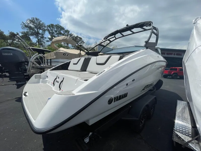 Slide: The Image of 2025 Yamaha Boats AR250, sleek white design, parked outdoors under cloudy sky. - 4