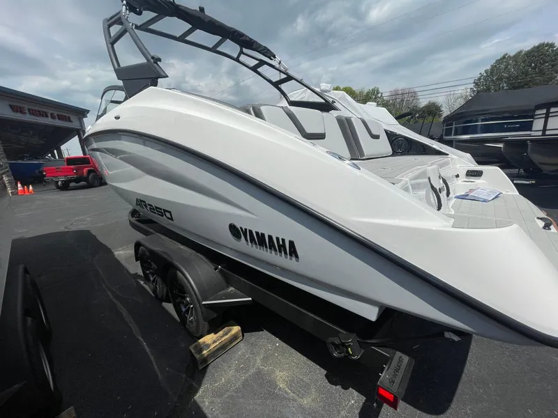 Slide: The Image of 2025 Yamaha AR250 boat on trailer, sleek design, parked outdoors. - 5