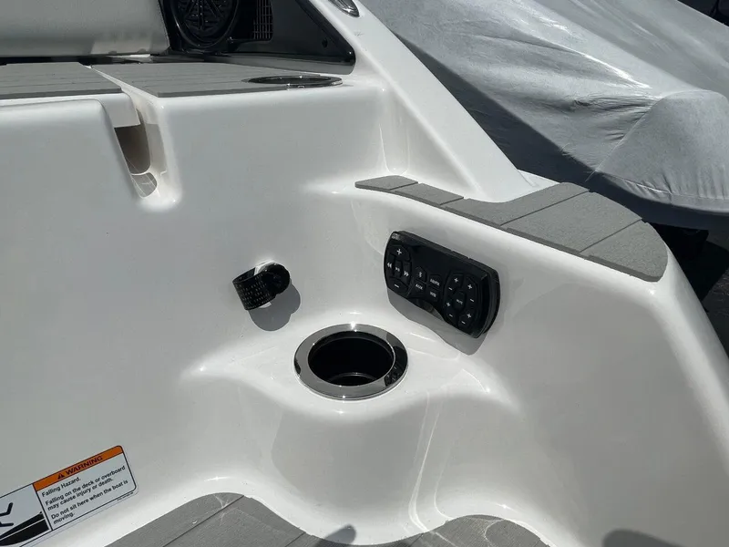 Slide: The Image of 2025 Yamaha Boats AR250 interior detail with cup holder and control panel. - 8