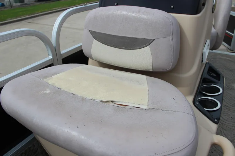 Slide: The Image of 2014 Sun Tracker Bass Buggy 18 DLX boat seat with visible wear and tear. - 10