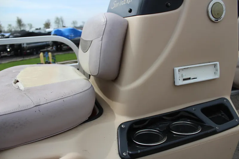 Slide: The Image of 2014 Sun Tracker Bass Buggy 18 DLX boat interior with beige seating and cup holders. - 11