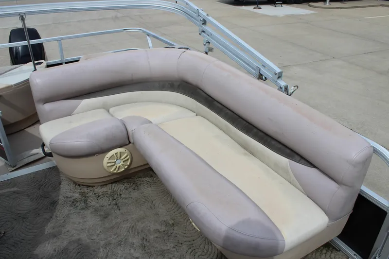 Slide: The Image of 2014 Sun Tracker Bass Buggy 18 DLX pontoon boat seating area with beige upholstery. - 14