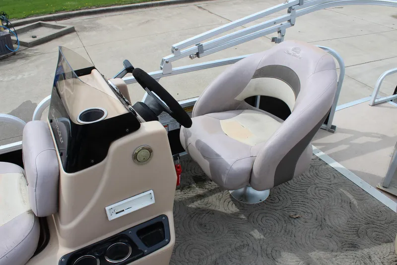 Slide: The Image of 2014 Sun Tracker Bass Buggy 18 DLX boat interior with steering console and seating. - 15