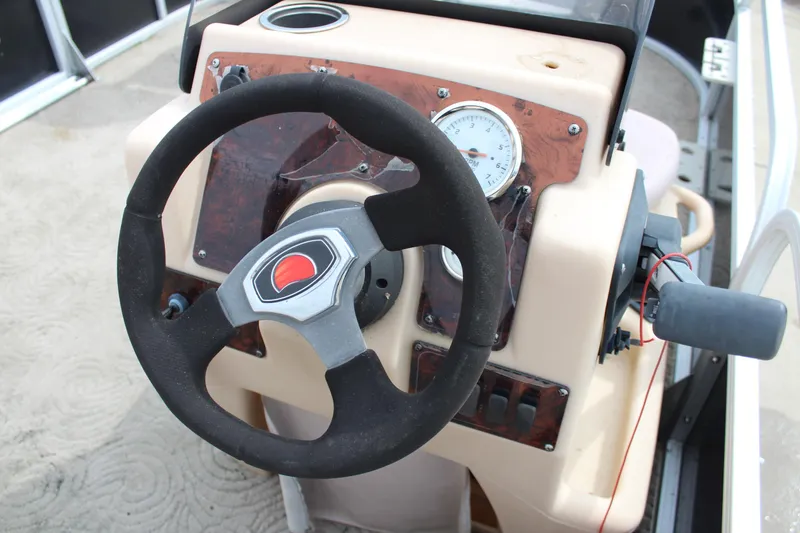Slide: The Image of Steering wheel and dashboard of 2014 Sun Tracker Bass Buggy 18 DLX boat. - 18