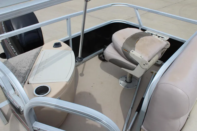Slide: The Image of 2014 Sun Tracker Bass Buggy 18 DLX boat interior with seating and control panel. - 19