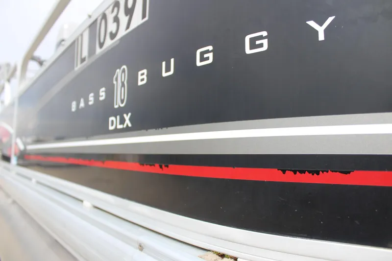Slide: The Image of 2014 Sun Tracker Bass Buggy 18 DLX boat side view with registration number. - 24