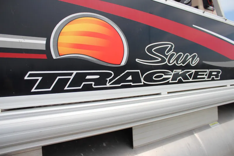 Slide: The Image of 2014 Sun Tracker Bass Buggy 18 DLX logo on boat exterior. - 25