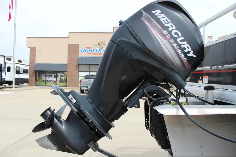 Slide: The Image of 2014 Sun Tracker Bass Buggy 18 DLX with Mercury outboard motor at dealership. - 28