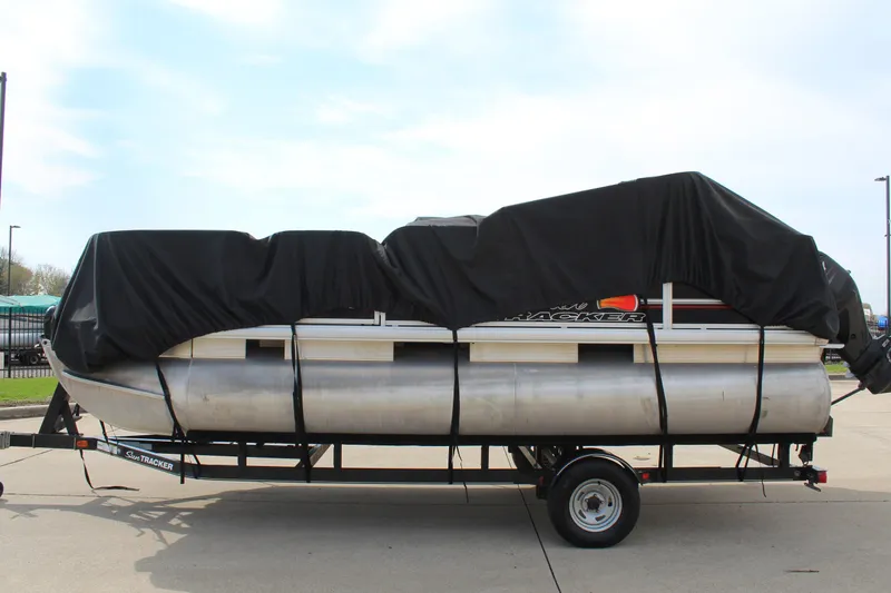Slide: The Image of 2014 Sun Tracker Bass Buggy 18 DLX pontoon boat covered on trailer. - 29