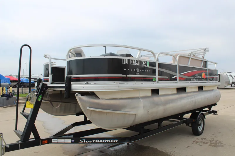 Slide: The Image of 2014 Sun Tracker Bass Buggy 18 DLX pontoon boat on trailer, outdoor setting. - 3