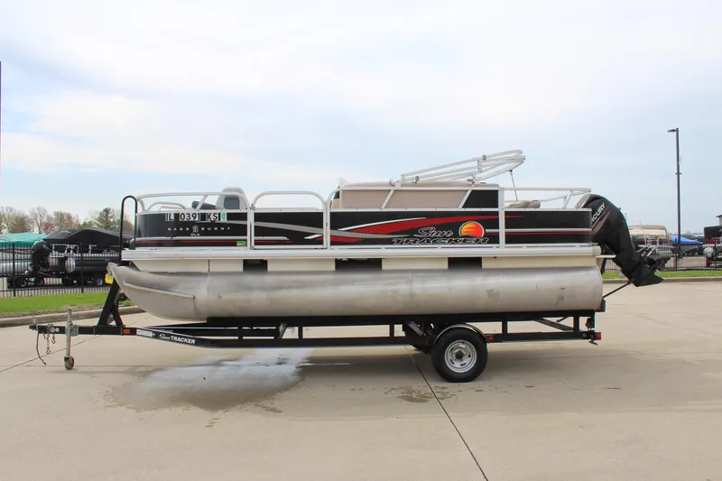Slide: The Image of 2014 Sun Tracker Bass Buggy 18 DLX pontoon boat on trailer in parking lot. - 4