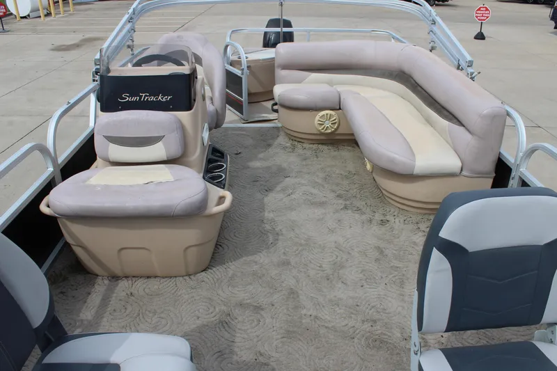 Slide: The Image of 2014 Sun Tracker Bass Buggy 18 DLX pontoon boat interior with seating and steering console. - 8