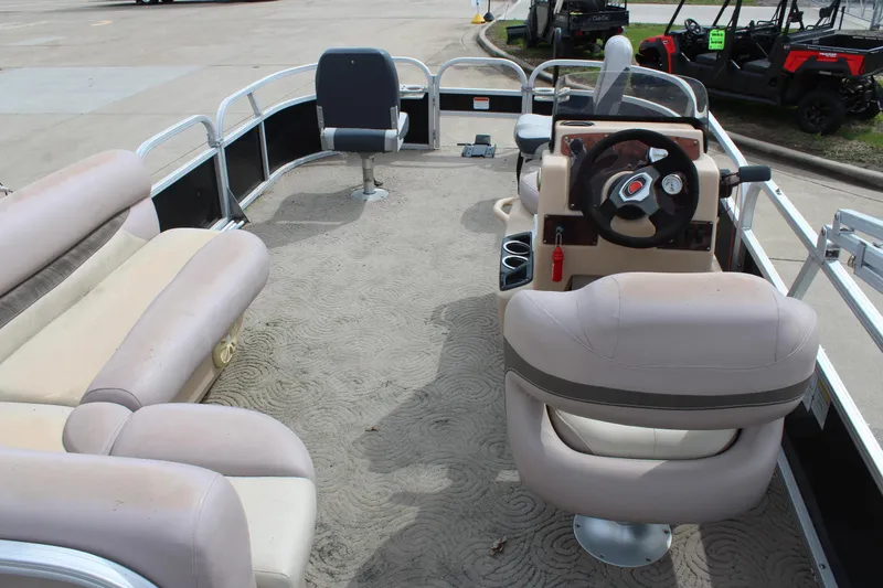 Slide: The Image of 2014 Sun Tracker Bass Buggy 18 DLX pontoon boat interior with seating and steering console. - 9
