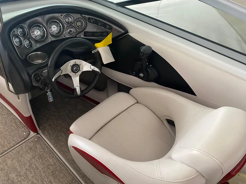 Slide: The Image of Interior of 2012 Crownline 21 SS boat with steering wheel and dashboard controls. - 10