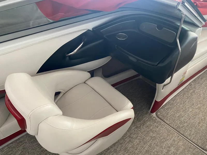 Slide: The Image of 2012 Crownline 21 SS boat interior with white and red seating and dashboard. - 11