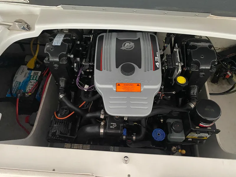 Slide: The Image of 2012 Crownline 21 SS boat engine compartment with visible components and wiring. - 13