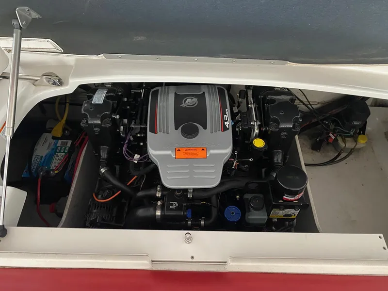 Slide: The Image of Engine compartment of a 2012 Crownline 21 SS boat, showcasing the motor and components. - 14