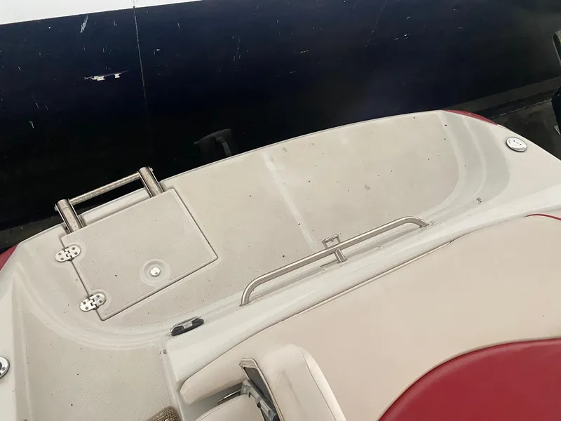 Slide: The Image of 2012 Crownline 21 SS boat deck with red and beige seating. - 6