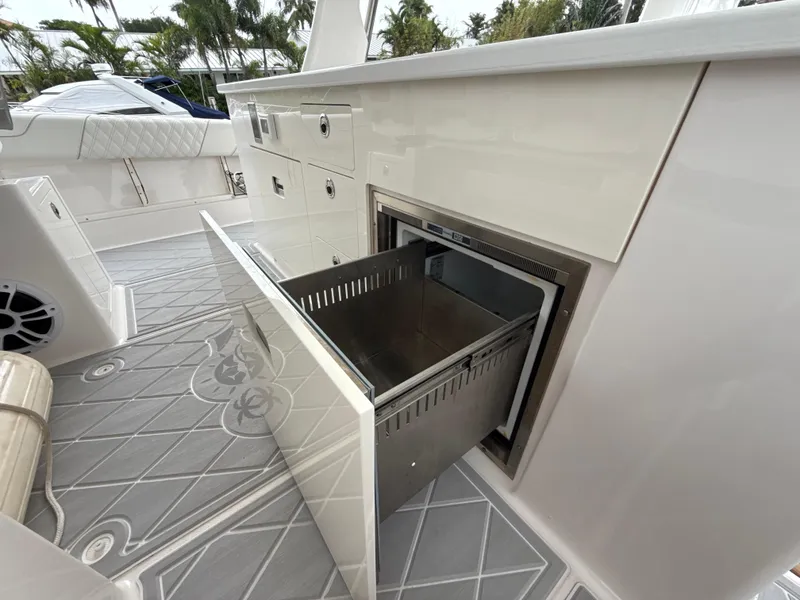 Slide: The Image of 2021 Regal 38 SAV boat interior with open storage compartment and sleek design. - 12