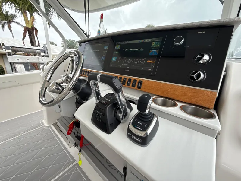 Slide: The Image of 2021 Regal 38 SAV boat helm with modern controls and touchscreen display. - 15