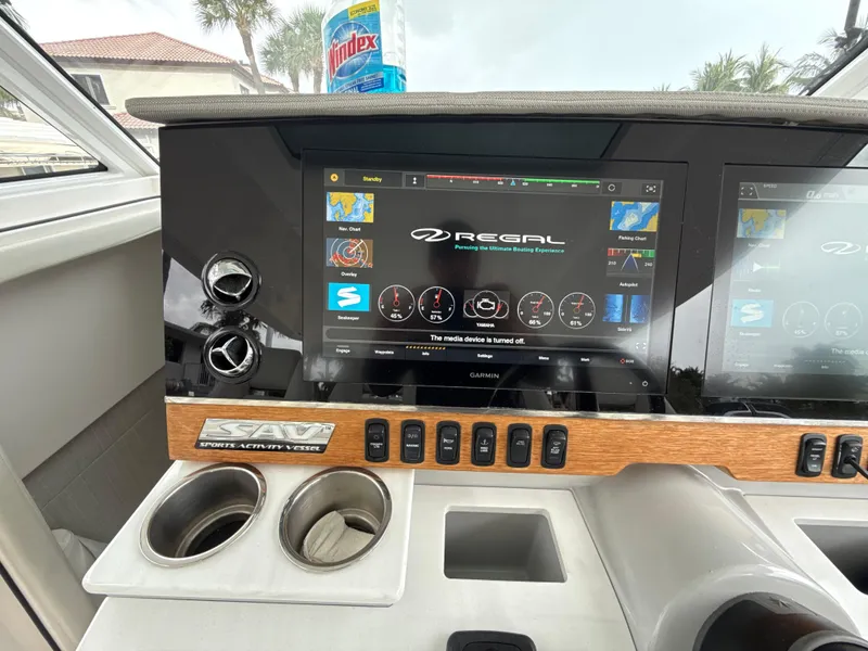 Slide: The Image of 2021 Regal 38 SAV dashboard with digital display and controls. - 17