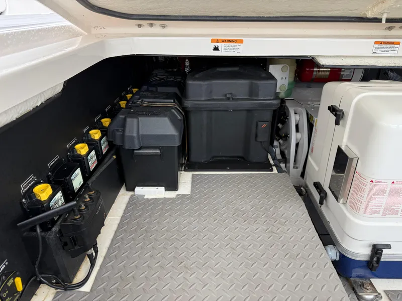 Slide: The Image of Engine compartment of 2021 Regal 38 SAV boat with batteries and equipment. - 32