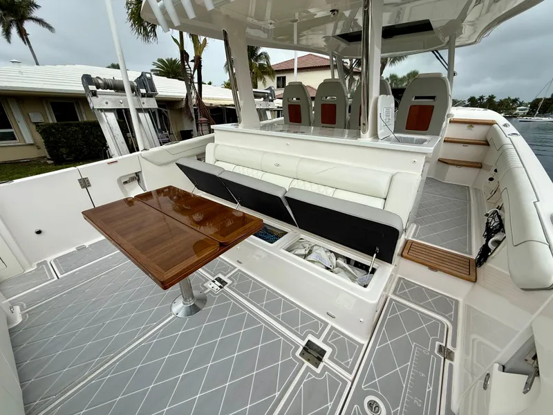 Slide: The Image of 2021 Regal 38 SAV boat interior with seating, table, and modern design. - 6