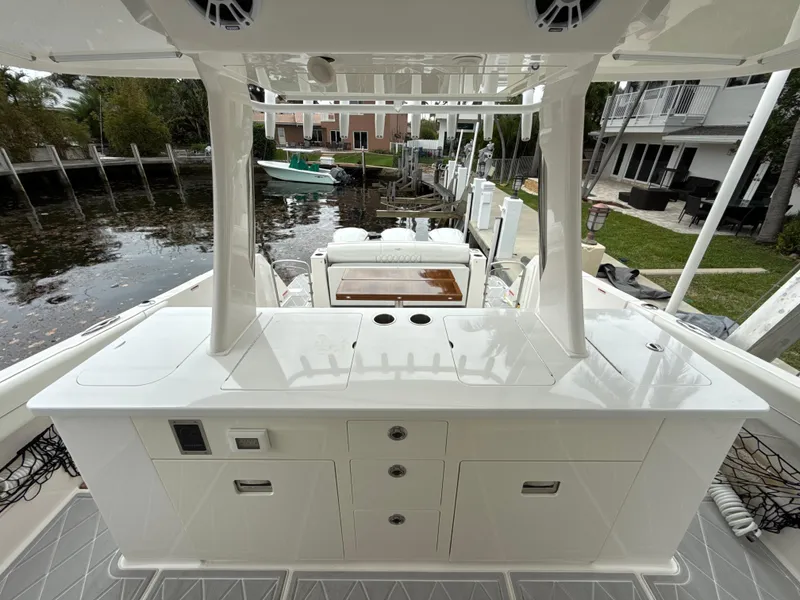 Slide: The Image of 2021 Regal 38 SAV boat interior with sleek white cabinetry and waterfront view. - 8