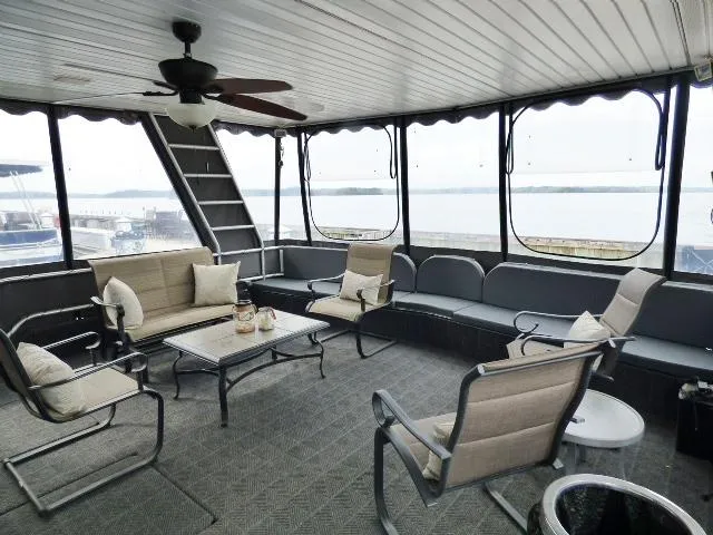 Slide: The Image of Spacious houseboat interior with comfortable seating, large windows, and scenic water views. Fantasy 17x85, 1998. - 1