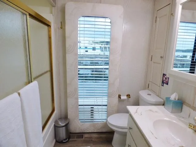 Slide: The Image of Bathroom with shower, toilet, and sink in a 1998 Fantasy 17x85 model. - 10