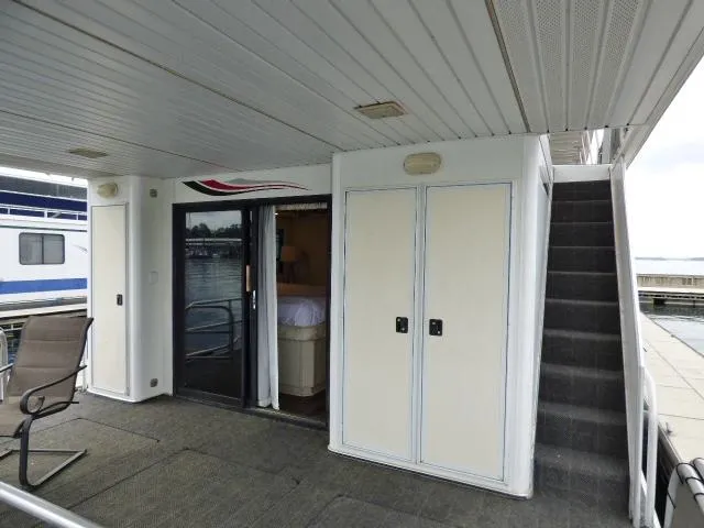 Slide: The Image of Houseboat deck with sliding glass door, stairs, and seating area, Fantasy 17x85 model, 1998. - 11