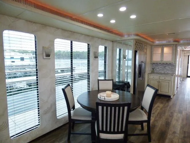 Slide: The Image of Luxurious 1998 Fantasy 17x85 houseboat interior with dining area, modern kitchen, and large windows. - 5