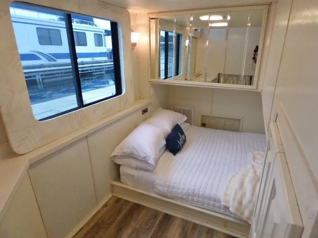 Slide: The Image of Cozy bedroom in a 1998 Fantasy 17x85 houseboat with window view and modern decor. - 7