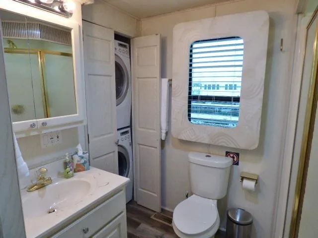 Slide: The Image of Compact bathroom with washer-dryer, sink, toilet, and window in a Fantasy 17x85 model. - 8