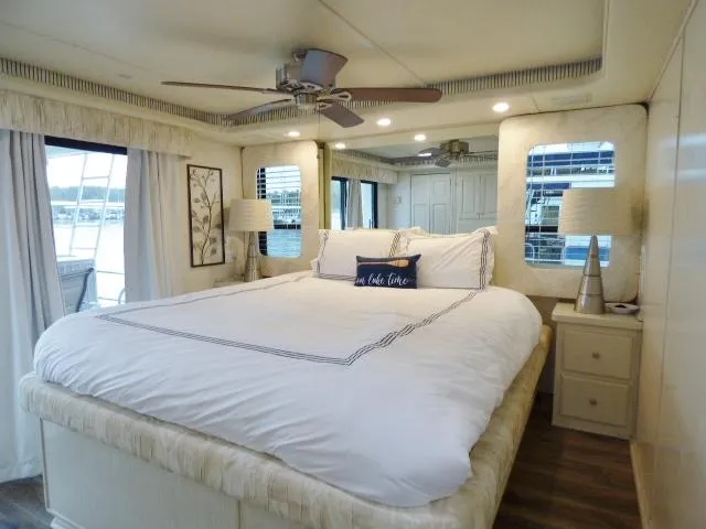 Slide: The Image of Luxurious bedroom on a 1998 Fantasy 17x85 houseboat with elegant decor and large windows. - 9