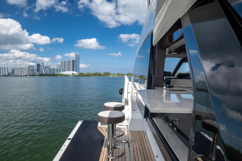 Slide: The Image of Luxury Galeon 640 Fly yacht with city skyline, 2020 model, docked on calm water. - 14