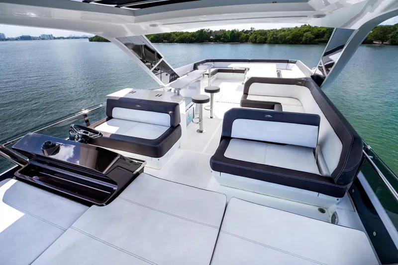 Slide: The Image of Luxurious 2020 Galeon 640 Fly yacht with spacious deck and seating area on serene water. - 17