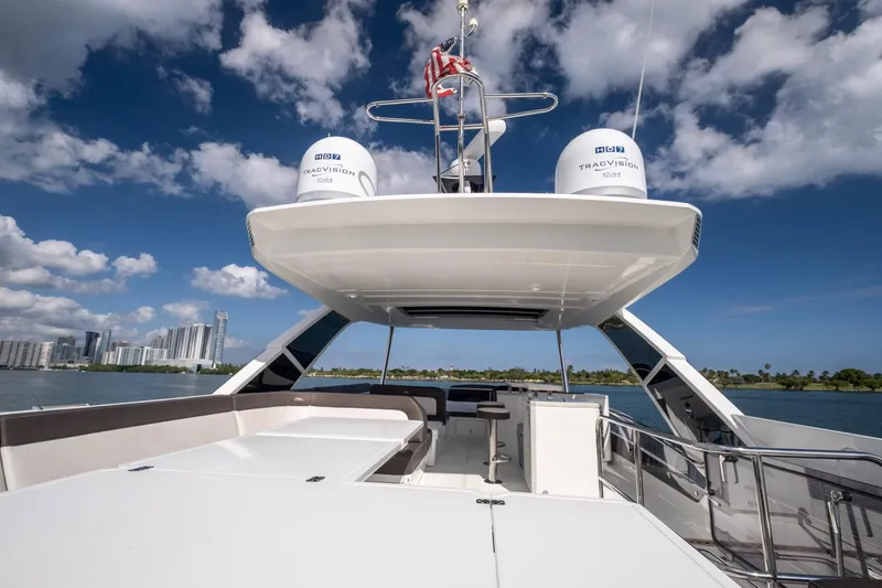 Slide: The Image of Galeon 640 Fly 2020 yacht with spacious deck, city skyline, and blue sky background. - 20