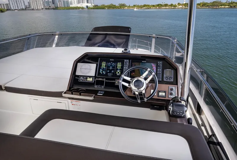 Slide: The Image of 2020 Galeon 640 Fly yacht helm with modern navigation controls on open water. - 21